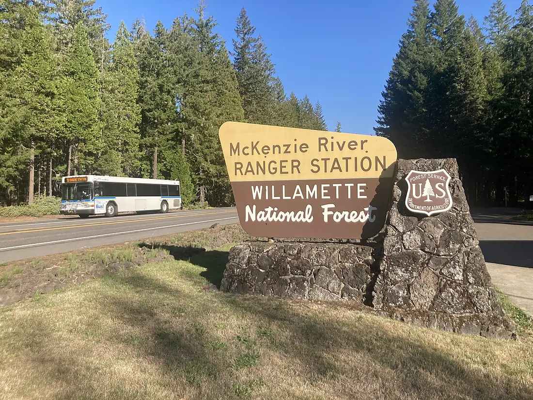 Lane Transit District bus 91 passes McKenzie River Ranger Station sign in Willamette National Forest